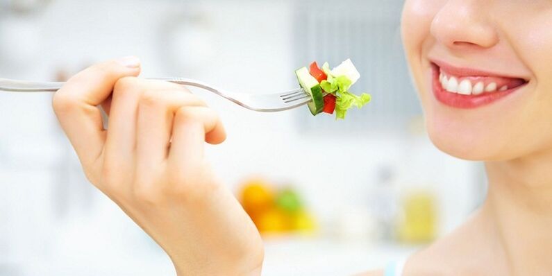 Girl eats vegetable salad, losing weight on her favorite diet